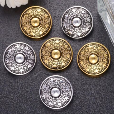 20 metal buttons featuring intricate patterns, great for garment embellishment and sewing